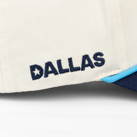 side view of Cream and Navy Hat with DALLAS text on side